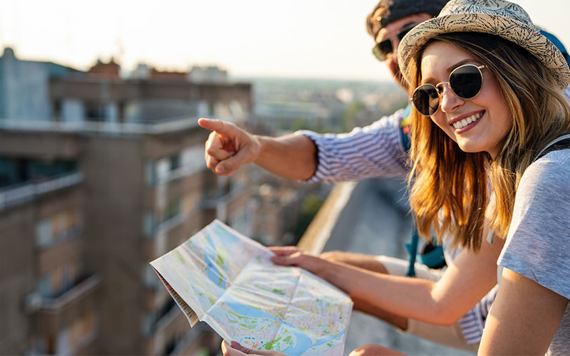 Male and female tourist looking at map 