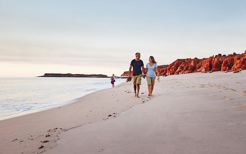 Couple walking along Western Beach, Kooljaman at Cape Leveque